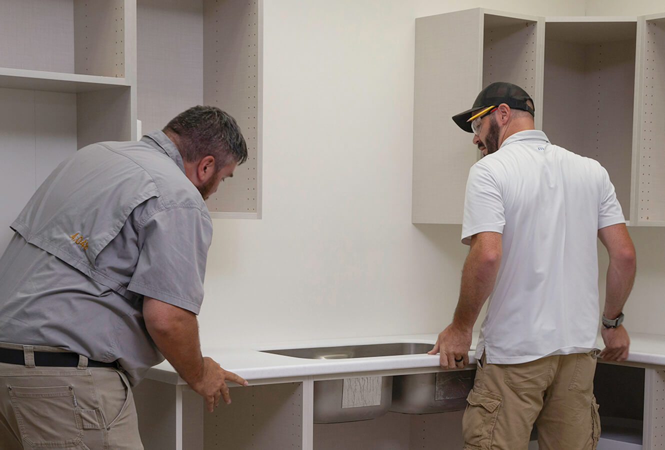 Two Men Installing A Countertop
