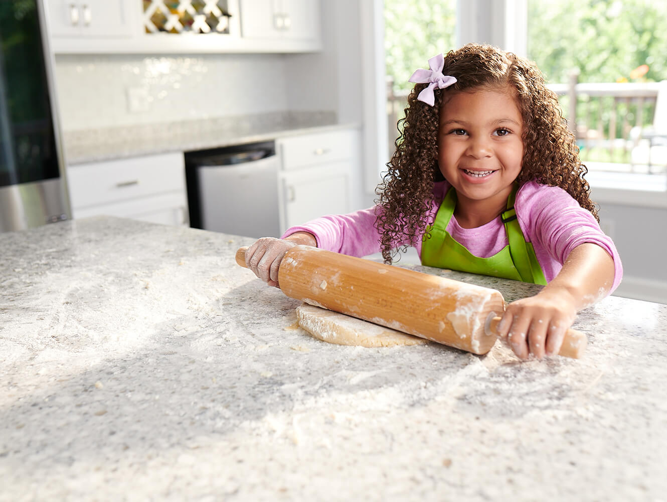 Kid Rolling Out Cookies On Counter