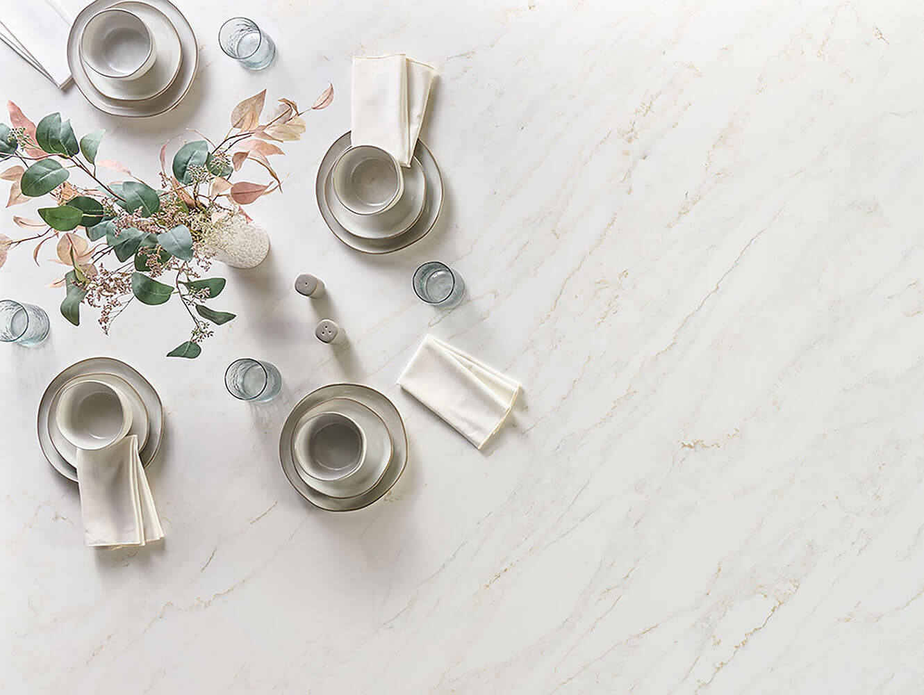 Serena Quartz Countertop with set out dishes and a flower arrangement