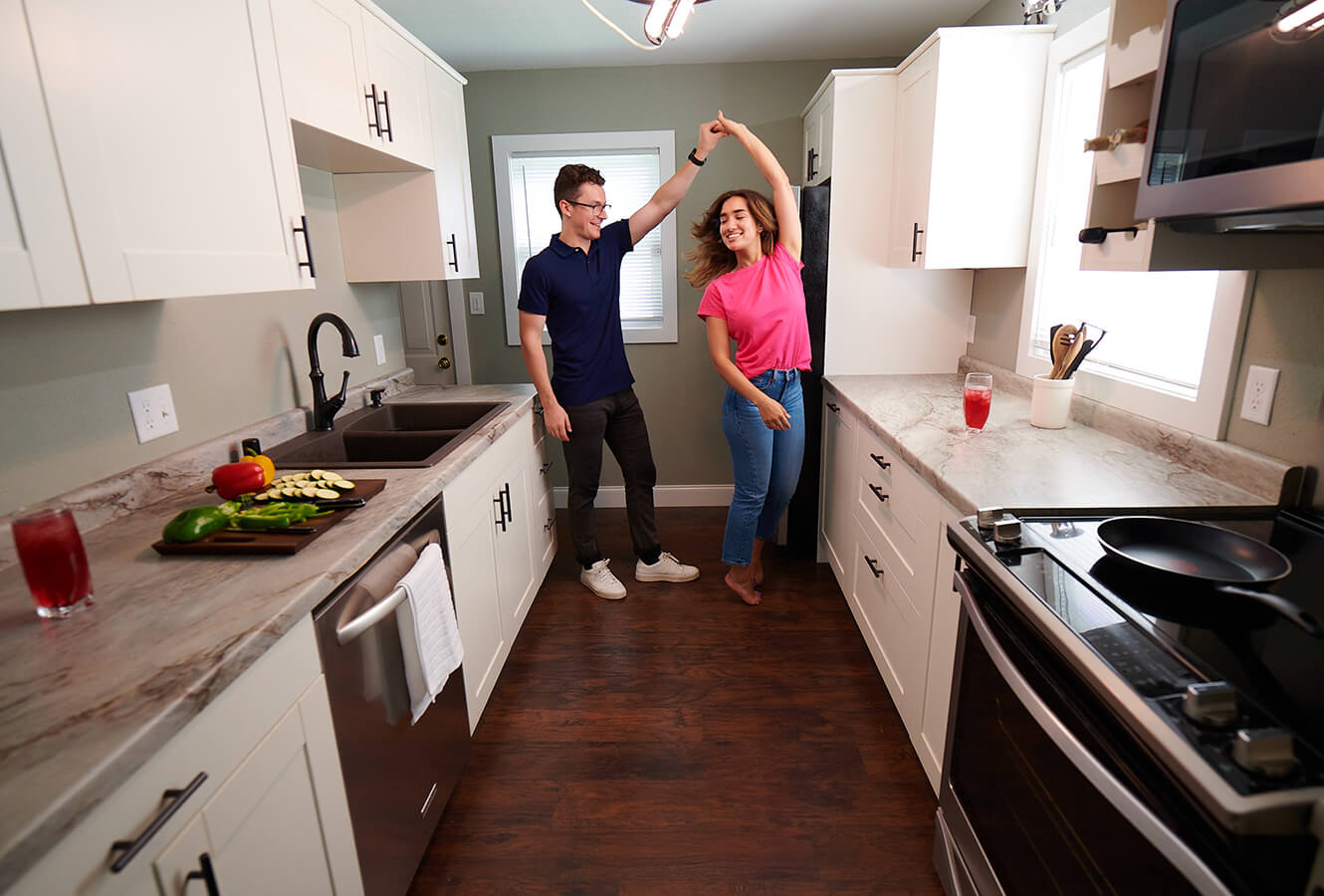 Young Couple Dancing In Kitchen